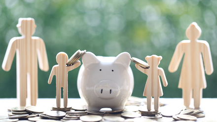 1949187265 Familie steckt Geld ins Sparschwein